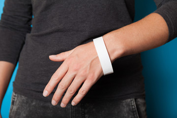 Paper wristband mockup, event bracelet on hand. Empty ticket wrist band design.