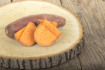 heap of sweet potato isolated on wooden background