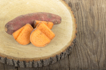 heap of sweet potato isolated on wooden background