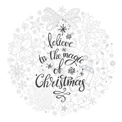 Believe in the magic of Christmas. Vector hand written calligraphic phrase in the shape of a circle with traditional festive elements.