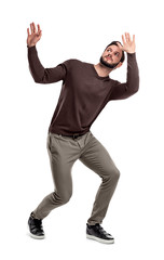 A bearded man in casual garb stands cowering under something dangerous above him.