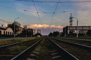 Fototapeta na wymiar Railway tracks going in the direction of a beautiful sunset.
