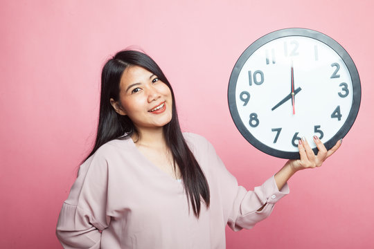 Young Asian woman with a clock.