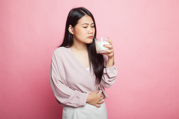 Asian woman drinking a glass of milk got stomachache.