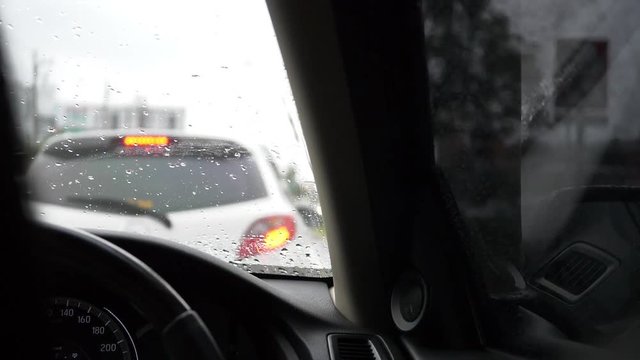 traffic jam in rainy day, slow motion windshield wiper swing clearing water rain