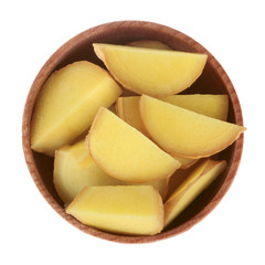 slices of ginger in wooden cup isolated on white. top view