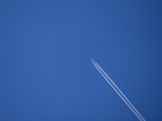 Trail of the plane against the blue sky