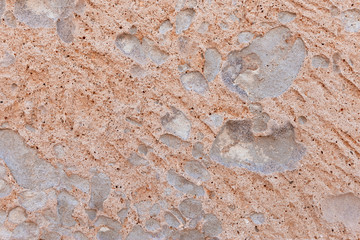 Background of rough texture stone surface of beige color.Antique concrete wall of limestone.