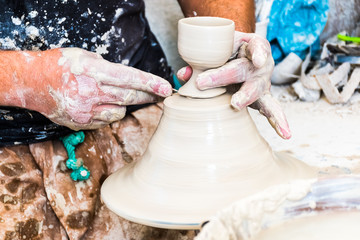 A moroccan pottery maker creates ceramics in a workshop in old medina of Fez, Morocco in Africa