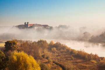 Abbey Tyniec surrounded by meandering Vistula river in colorful autumn scenery. Worth seeing nature reserve of Krakow - obrazy, fototapety, plakaty