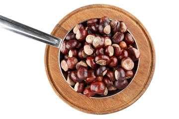 Many chestnuts in frying pan on wooden plate