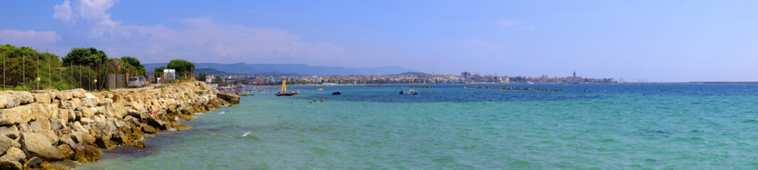 Alghero, Italy - Panoramic view of the Gulf of Alghero with historic quarter and Alghero old town in background