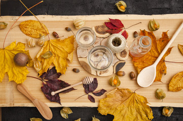 Cooking jam. Homemade blanks in the autumn on a background of wood, Physalis, yellow leaves, acorns
 