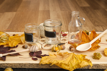 Cooking jam. Homemade blanks in the autumn on a background of wood, Physalis, yellow leaves, acorns
 