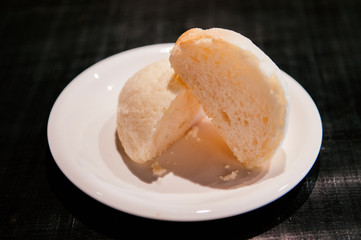Japanese famous Melon bun cut into half on white plate of Hida Furukawa town, Gifu. Japan