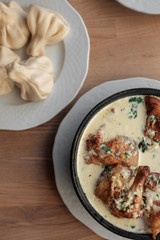 Chicken in a creamy sauce with garlic and herbs, khinkali. 