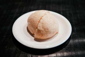 Japanese famous Melon bun cut into half on white plate of Hida Furukawa town, Gifu. Japan