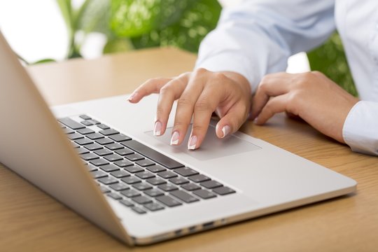 Closeup of a Businesswoman Typing on a Laptop