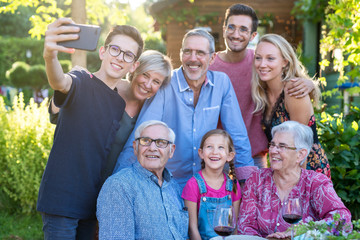during a bbq a teenager does a selfie with the whole family