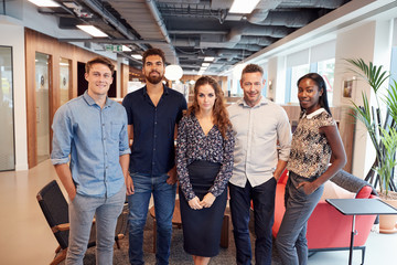 Portrait Of Casually Dressed Businessmen And Businesswomen In Modern Office Space