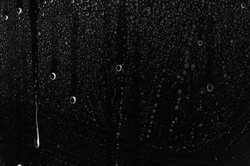 black wet background / raindrops for overlaying on window, concept of autumn weather, background of...
