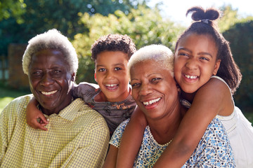 Senior black couple outdoors with grandchildren, close up