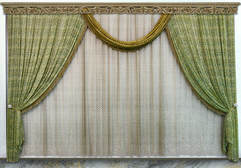Modern design living room. Green curtains made of natural fabric, translucent tulle and carved wooden cornice © fotiy