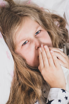 Sick girl in bed with bad cough