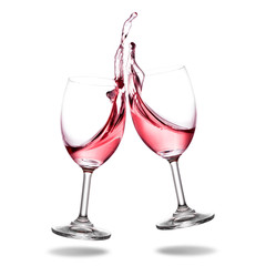 Cheering red wine with splashing out of glass isolated on white background.