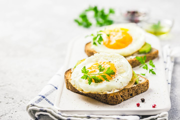 Avocado, cream cheese and fried egg sandwich. Selective focus, space for text.