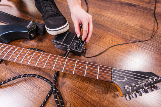 Man setting up guitar equipment