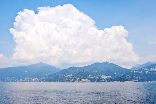 Big clouds above mountains on shore