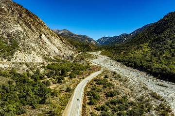 Aerial view of Forest Falls and Oak Creek in the San bernardino Mountains and National Forest with blue sky, green and yellow trees and plants