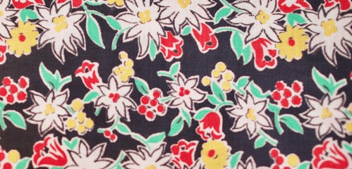 Fragment of colorful retro tapestry text. Fabric striped, flowered texture.