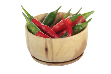 heap of chili pepper in wooden cup isolated on white background