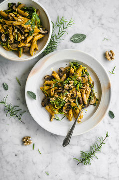 Pumpkin roasted mushroom penne with rucola, walnuts, and herbs