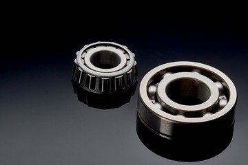 Close-up of a set of ball and roller bearings on a dark background