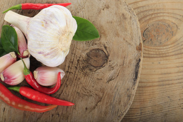 heap of chili pepper with garlic on wooden background