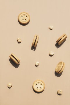 Round walnut cookies on a caramel coloured background.