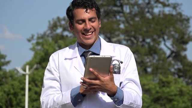 Happy Hispanic Doctor Using Tablet