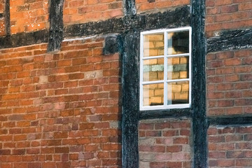 Closeup of old brick Wall of an industrial or historical building with old big window