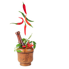 heap of chili pepper in wooden mortar isolated on white background