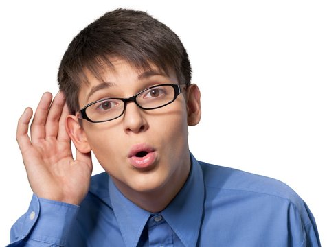 Young man wearing glasses and cupping his ear