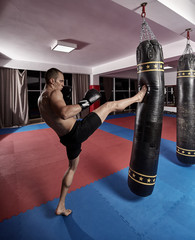 Muay thai fighter working with heavy bag