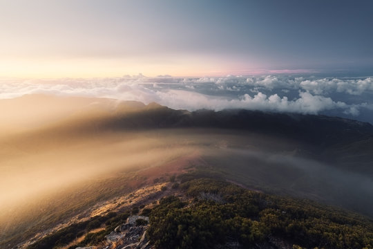 Aerial shot of mountains with clouds in the background