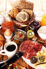 breakfast on table with bread buns, croissants, coffe and juice on new years eve