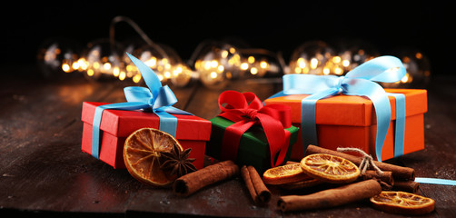 Fragrant star anise and cinnamon on wooden table and christmas gifts. xmas gift concept.