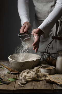 Midsection of woman dusting flour in bowl