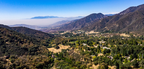 Aerial, drone view of Oak Glen located between the San Bernardino Mountains and Little San Bernardino Mountains with several apple orchards before the Fall color change