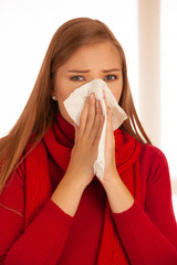 woman sneezes holding a handkerchief nasal